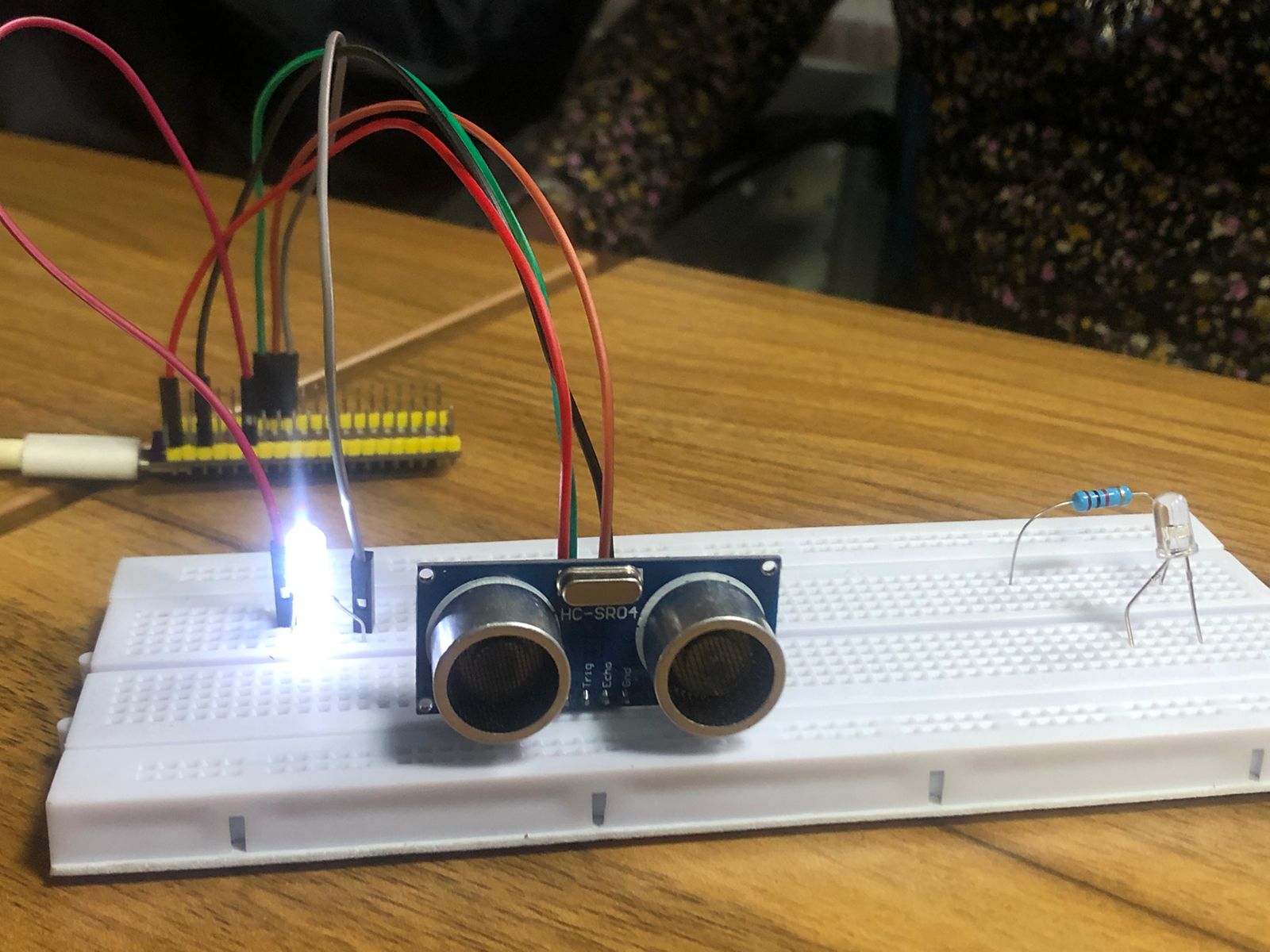 Close up of the HC-SR04 sensor and illuminated LED